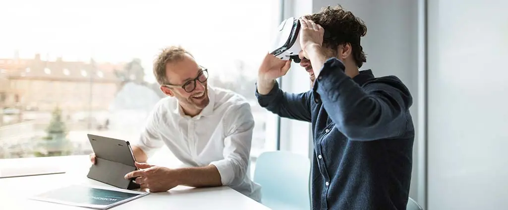 Two men using an AR/VR headset in the workplace